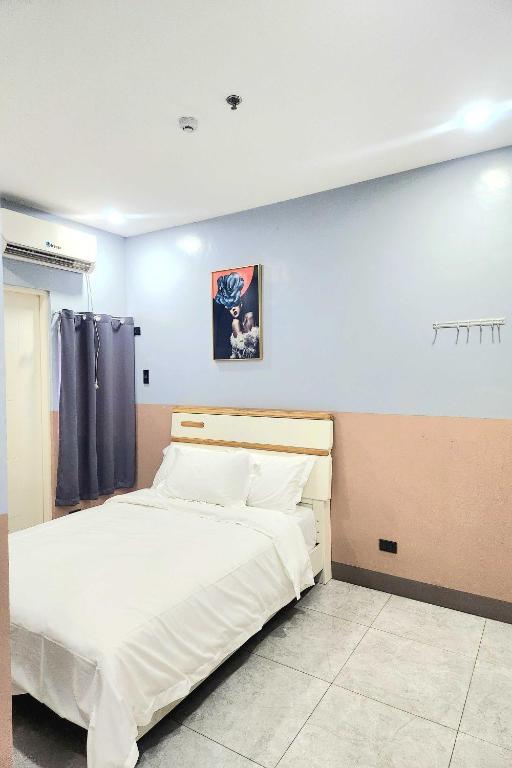 Postel nebo postele na pokoji v ubytování Qingqing Hotel Pasay Manila near MOA
