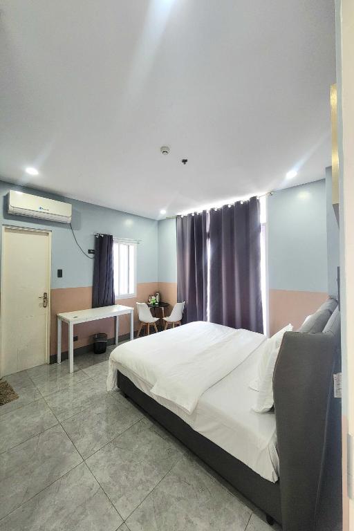 Postel nebo postele na pokoji v ubytování Qingqing Hotel Pasay Manila near MOA