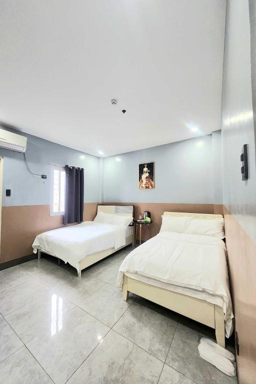 Postel nebo postele na pokoji v ubytování Qingqing Hotel Pasay Manila near MOA