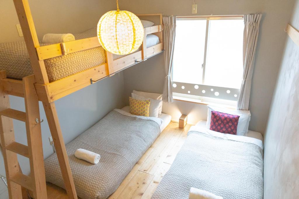 Postel nebo postele na pokoji v ubytování Tokyo Hikari Guesthouse