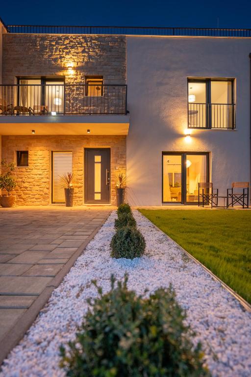 a house with a pathway in front of it at Rooftop Holiday House in Brodarica