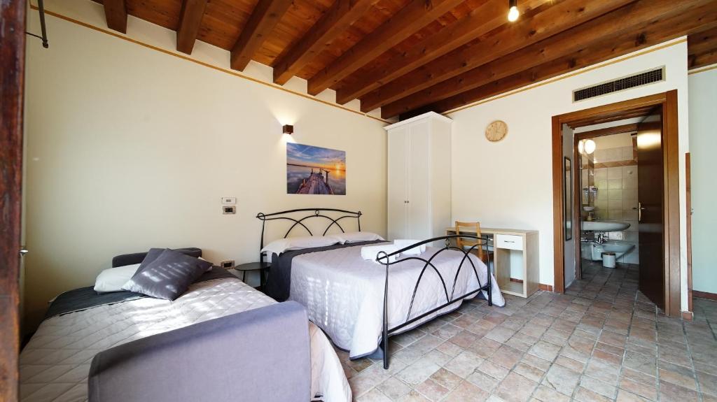 Postel nebo postele na pokoji v ubytování B&B Relax Rooms - Peschiera del Garda