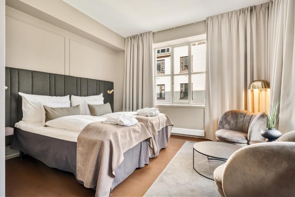 Postel nebo postele na pokoji v ubytování Home Hotel Bryggen