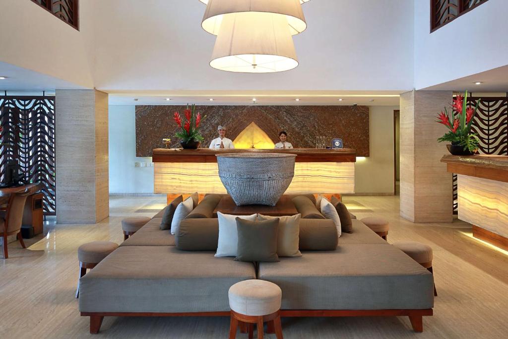 a large couch in the middle of a lobby at The Magani Hotel and Spa in Legian