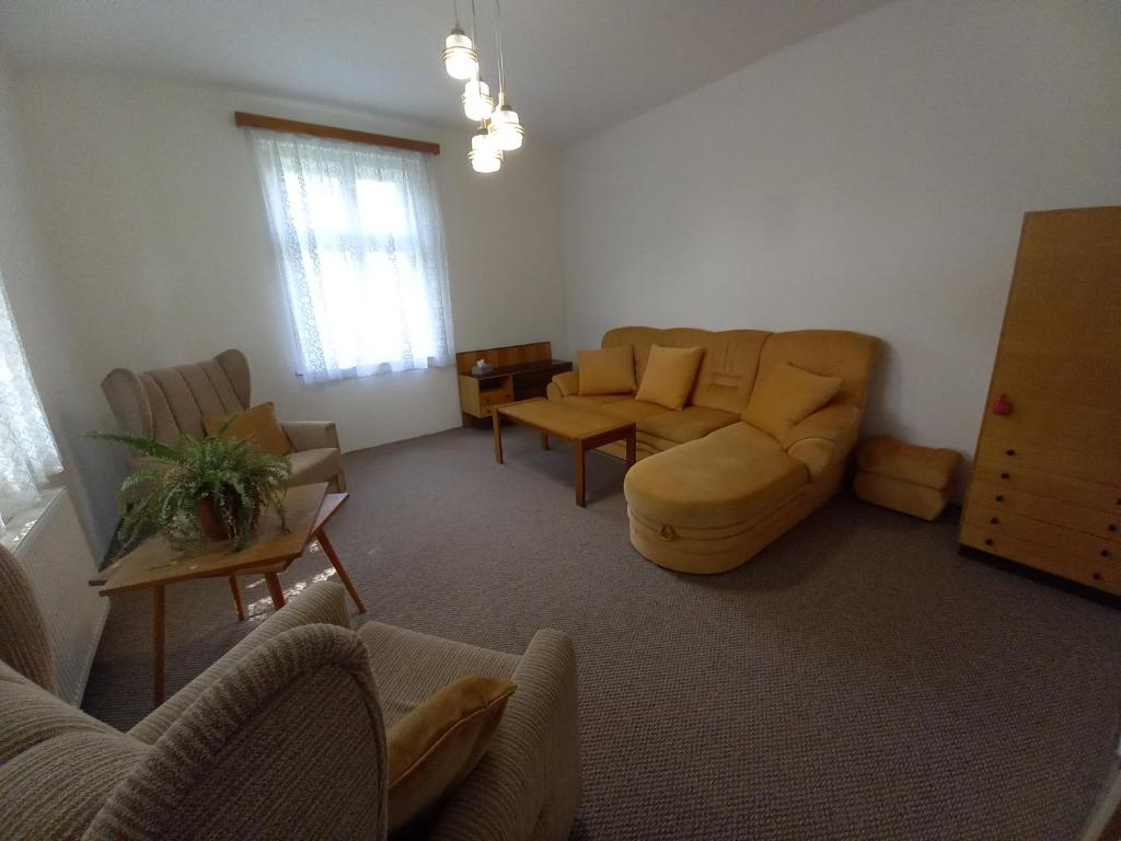 a living room with a couch and a table at Vila Kotlářská in Děčín