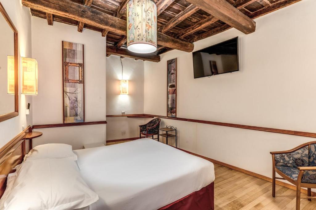 Postel nebo postele na pokoji v ubytování Hotel Santa Prassede