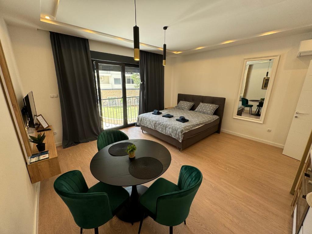 a living room with a couch and a table and chairs at Epicenter Suite in Trebinje