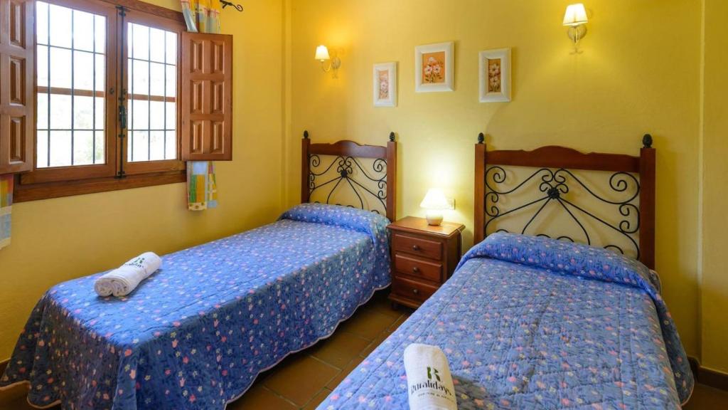 Posteľ alebo postele v izbe v ubytovaní Cortijo Los Tulipanes Periana by Ruralidays
