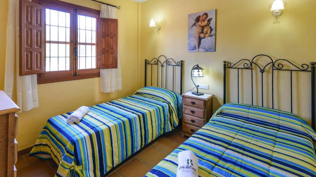 Posteľ alebo postele v izbe v ubytovaní Cortijo Los Tulipanes Periana by Ruralidays