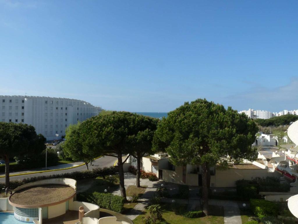 une vue d'une ville avec des arbres et des bâtiments dans l'établissement Studio cabine, piscine, proche plage et commerces - FR-1-328-219, à La Grande Motte