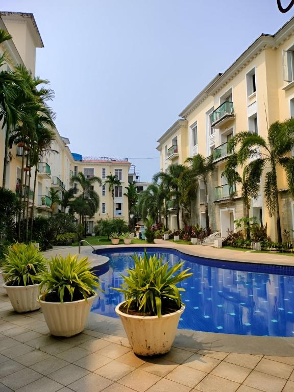 a pool in front of some apartment buildings at Ronne's aparthotel in Arpora