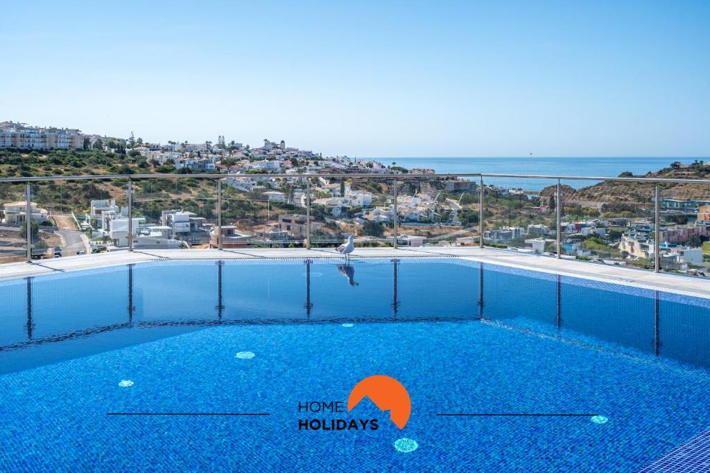 a swimming pool with a view of the ocean at #234 Serenity Refuge w Balcony and Pool in Páteo