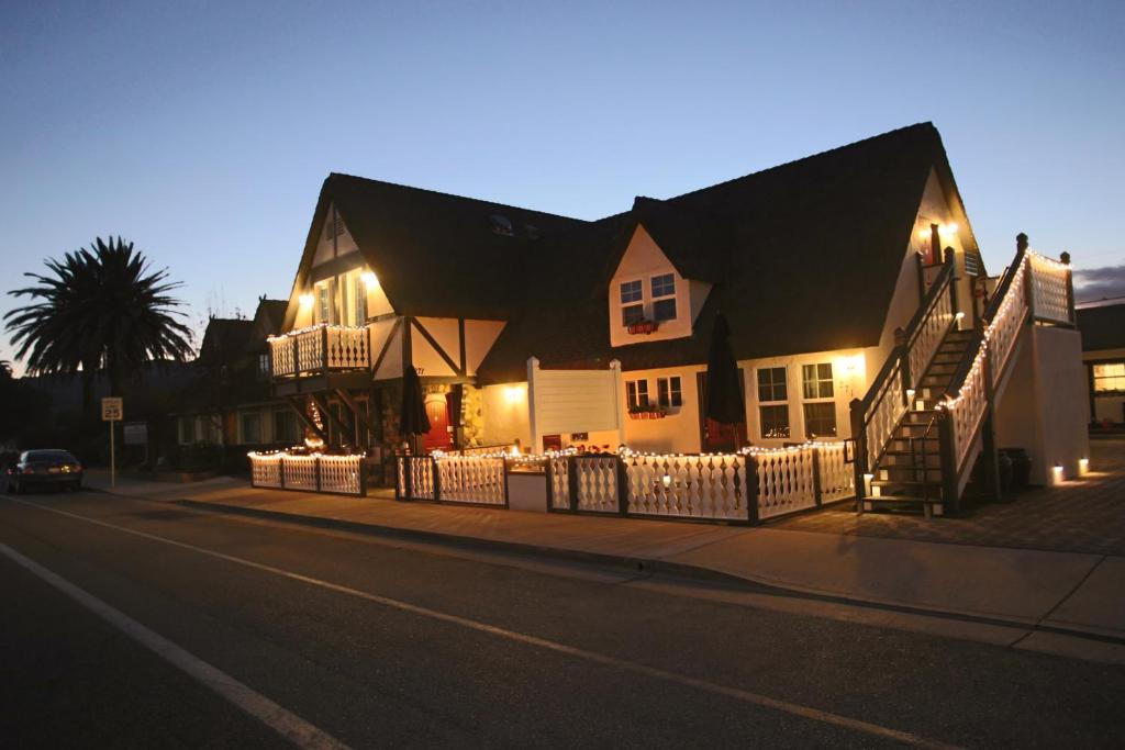 a house with a fence on the side of a street at New Haven Inn in Solvang