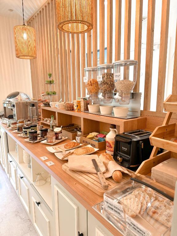 a kitchen with a counter with food on it at Hôtel de Provence in Cannes