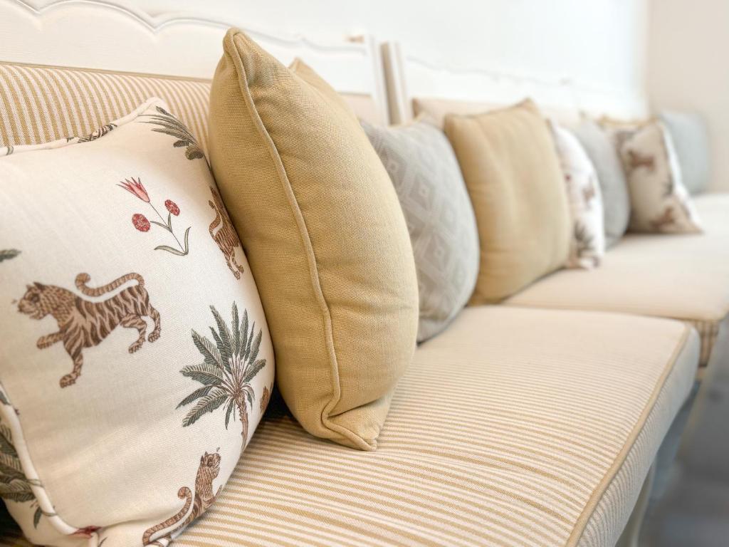 a row of pillows sitting on a couch at Hôtel de Provence in Cannes