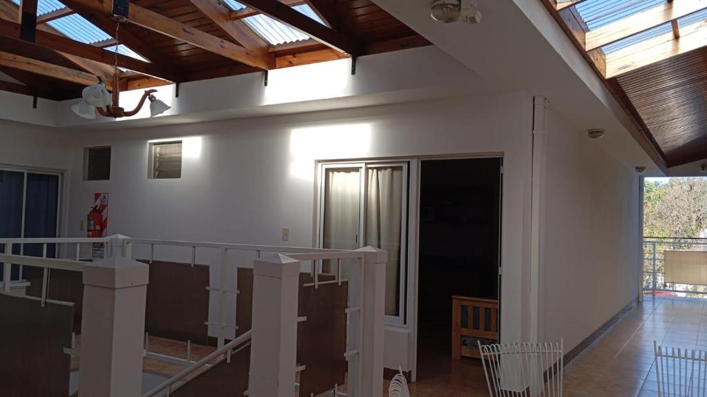 a room with white walls and wooden ceilings at Departamentos MR in Villa Elisa