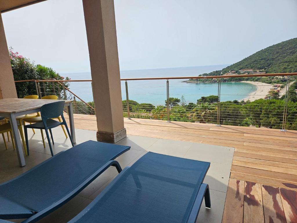 a balcony with a table and chairs and a view of the ocean at SERENA-Piscine privée- Vue Mer in Conca