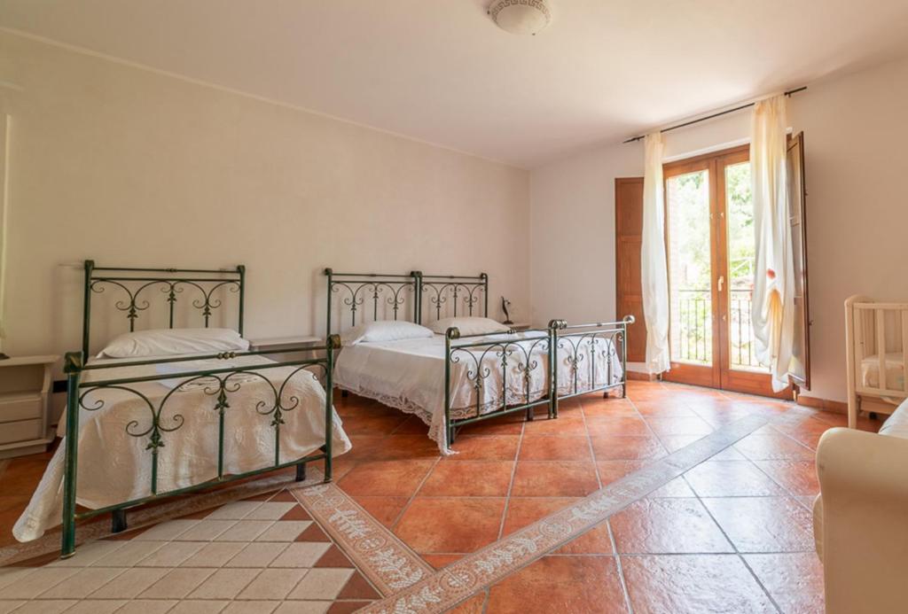 Postel nebo postele na pokoji v ubytování Agriturismo San Basilio