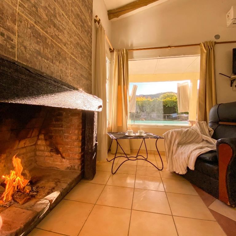 a living room with a fireplace and a couch at El Solar Casas de Campo 2 in Valle Grande