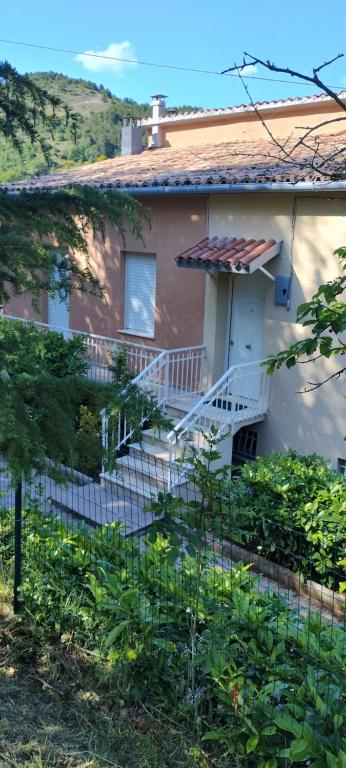 a house with a staircase in front of it at La casa di Gianfri in Esanatoglia