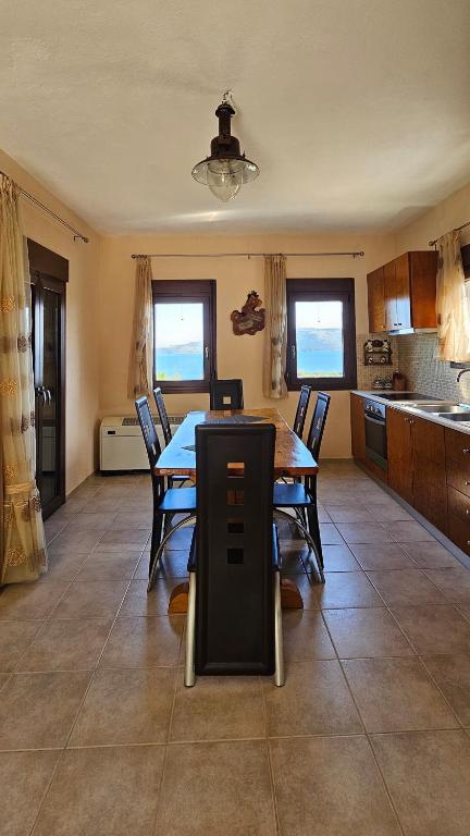 a kitchen and dining room with a table and chairs at Villa Nikos in Agios Dimitrios