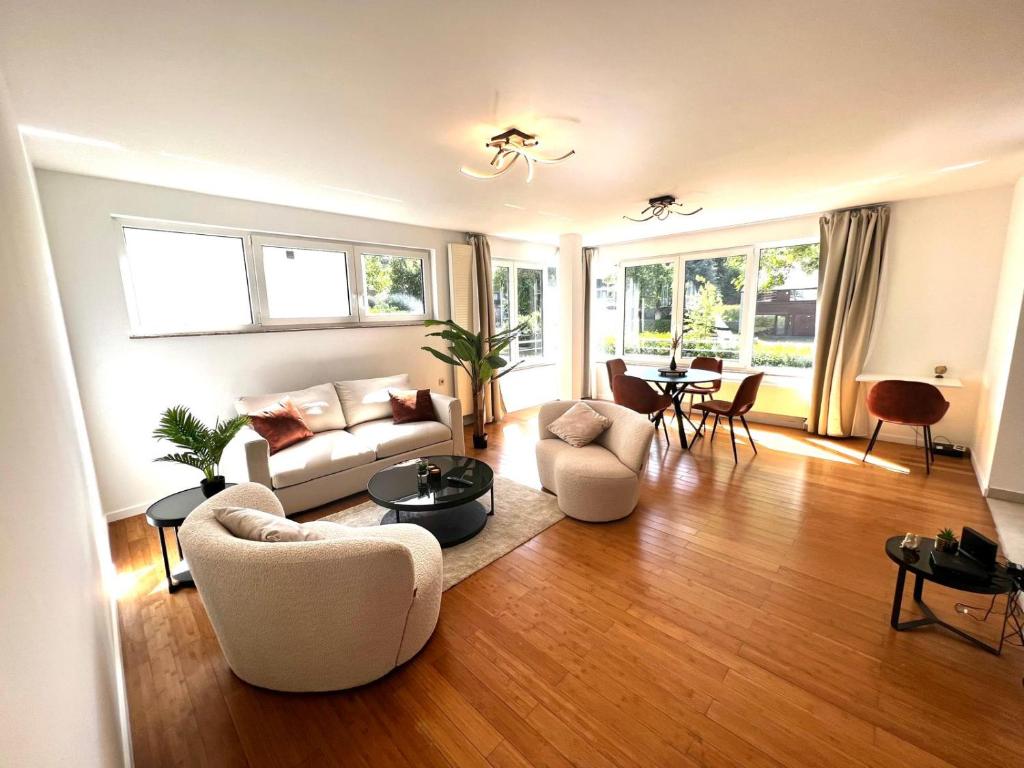 a living room with a couch and chairs and a table at Wolu suites in Brussels