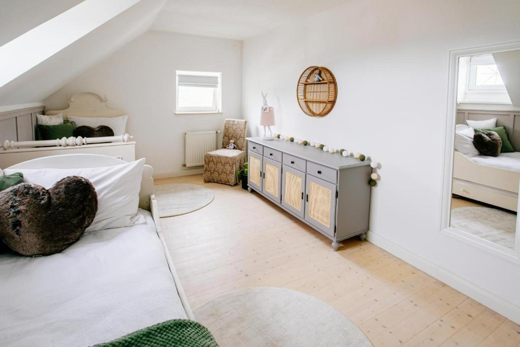 a bedroom with white walls and a bed and a window at Cottage Salzburg in Nußdorf am Haunsberg