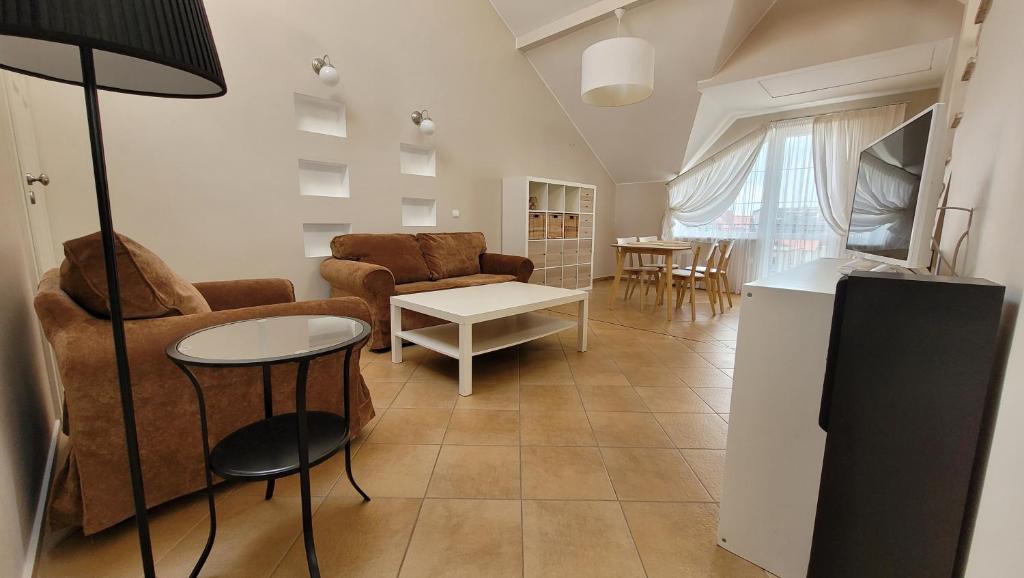 a living room with a couch and a table at NIKA Pokoje u Weroniki in Władysławowo