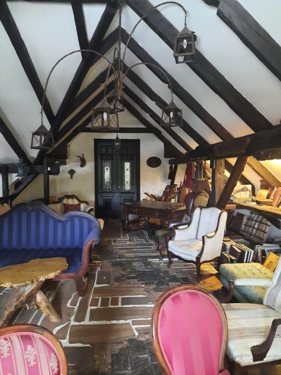 a room with chairs and tables in a room at Rustic Charm a Unique and Antique Apartment in Zagreb