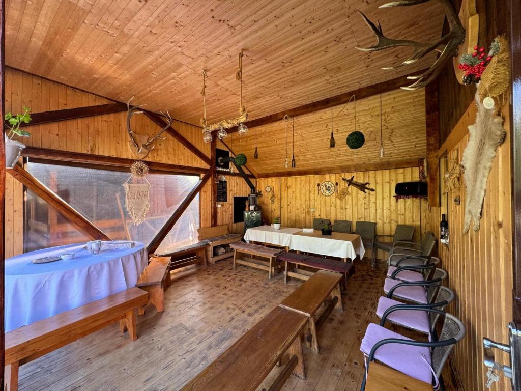 a room with a tub and some chairs in it at Casa Mariei in Vama Buzăului