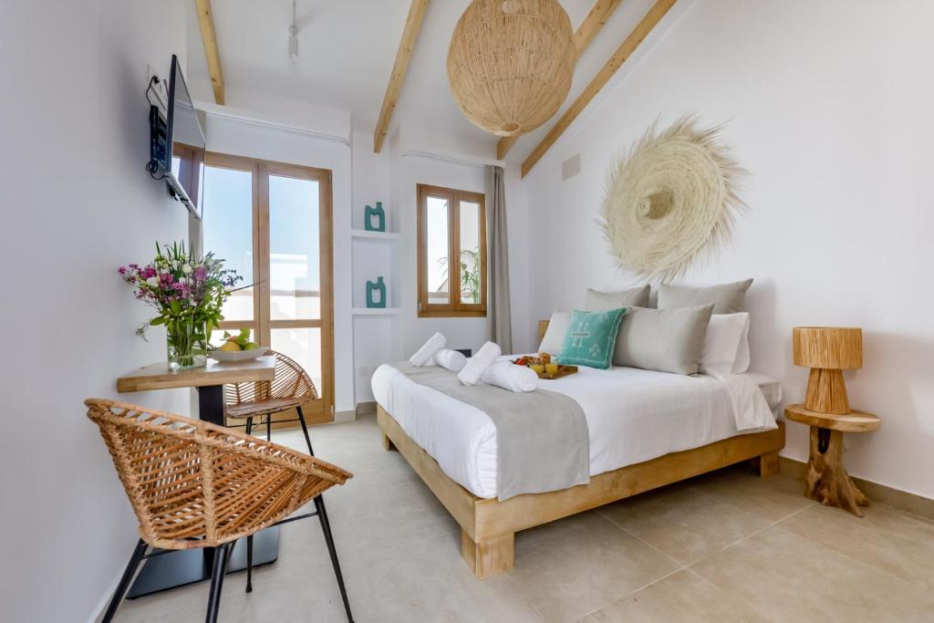 a bedroom with a bed and a table and chairs at MIMAR ALTEA ROOMS - Tranquil in Altea