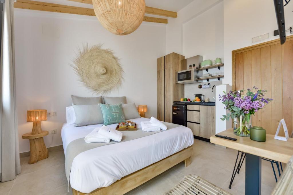 a bedroom with a large bed with two towels at MIMAR ALTEA ROOMS - Tranquil in Altea