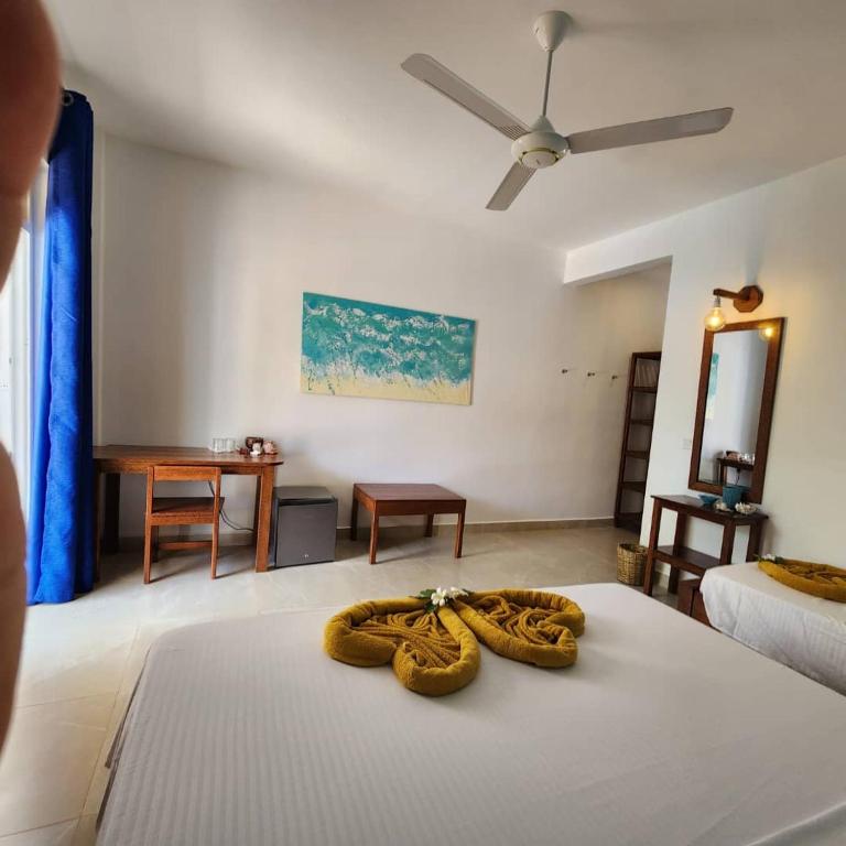 a bedroom with a bed with two towels on it at Olzadia Boutique Hotel in Michamvi