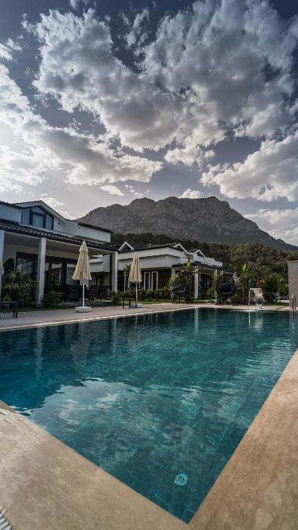 a large swimming pool in front of a building at - Meta Homes - in Kemer