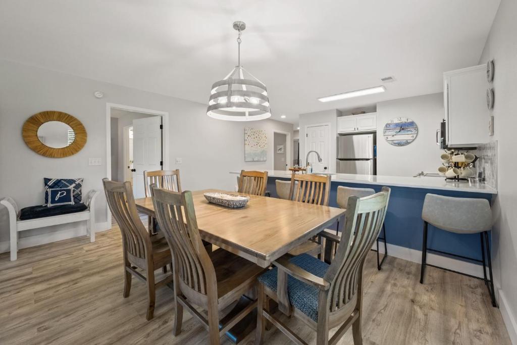 a kitchen and dining room with a wooden table and chairs at 55A 4th Hole Retreat at True Blue condo by Peace Vacations in Pawleys Island