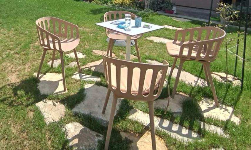two chairs and a table in the grass at Villa Ilidza فيلا إليدزا in Ilidza