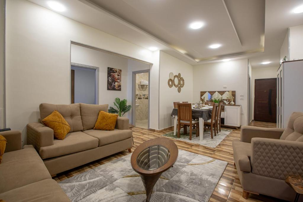 a living room with a couch and a table at Skyline Premium Properties in Alexandria