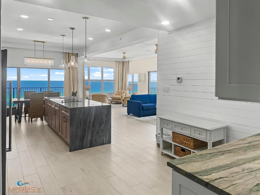 a kitchen and living room with a view of the ocean at ETW#6004-Penthouse Beachfront Condo–Amazing Views in Fort Walton Beach