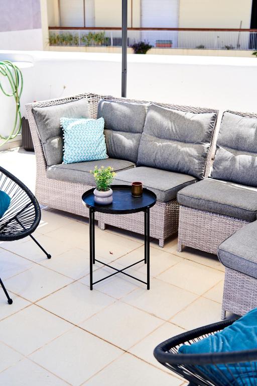 a couch and a table on a patio at Baron Faro - Guest House in Faro