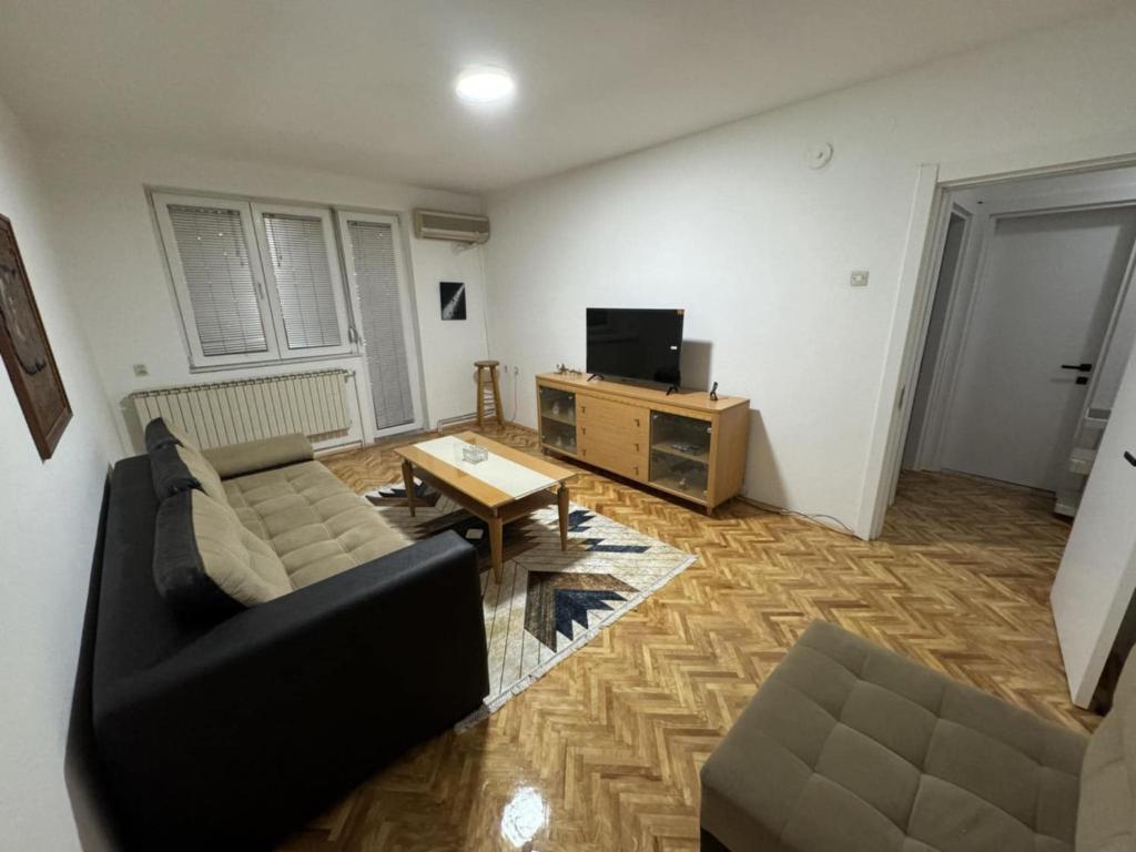 a living room with a couch and a table at The Great Escape in Bitola