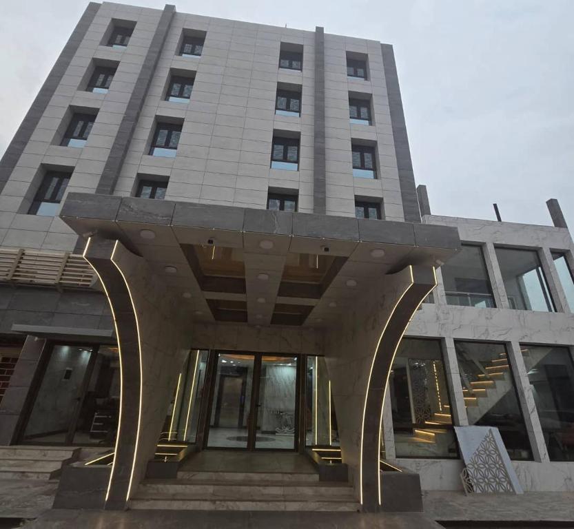a tall building with an entry way in front of it at La Luna in Bangui