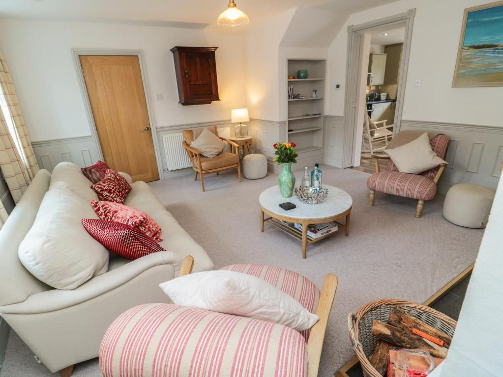 a living room with a couch and a table at Eider Cottage in Morpeth