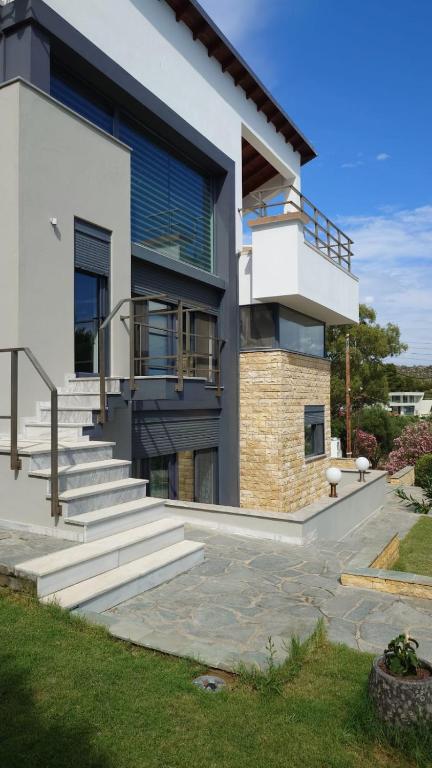 a modern house with stairs and a balcony at Villa Stadi in Nikiti