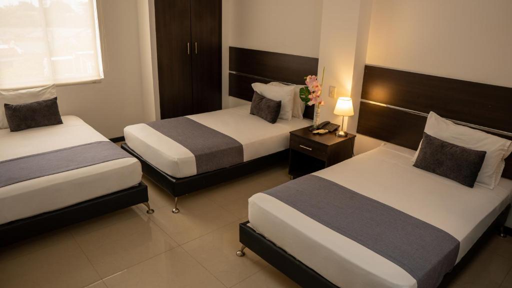 Postel nebo postele na pokoji v ubytování Diagonal Hotel Chipichape