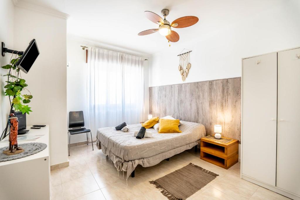 a bedroom with a bed and a ceiling fan at On the way!* in Portimão