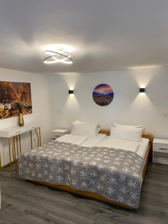 a bedroom with two white beds and a ceiling at Familie Moisil in Daun