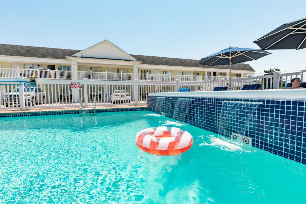 a swimming pool with a lifebuoy in the water at The Beach Club on Madison Avenue in Cape May