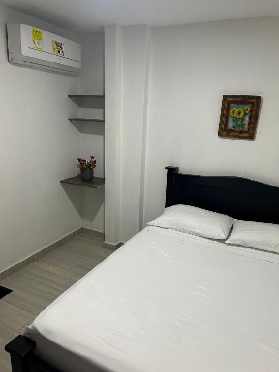 Postel nebo postele na pokoji v ubytování Hotel Encanto Vallenato
