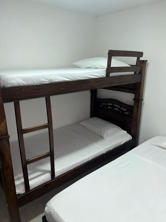 Postel nebo postele na pokoji v ubytování Hotel Encanto Vallenato