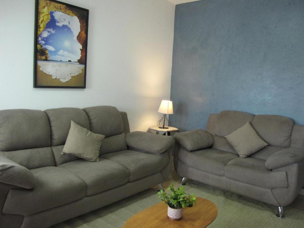 a living room with a couch and a table at RCM Vilas - Apartamento n 12 in Joinville